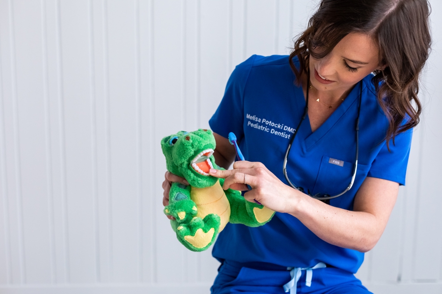 Using a stuffed animal to demonstrate proper teeth brushing, helps children to understand and relate to their dentist.