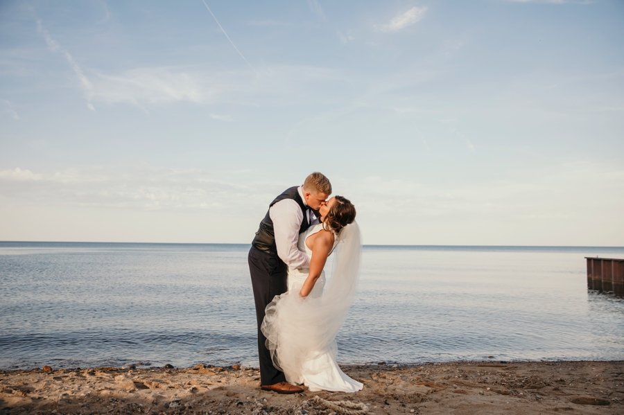 Austin and Amy taking their beachfront photos during their Lakeport Michigan Wedding