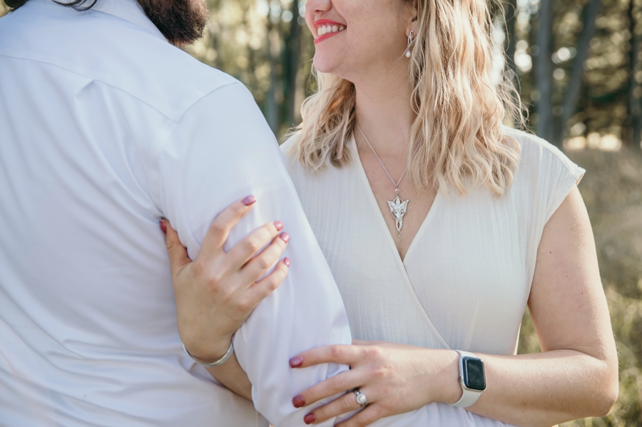 Adding a personal touch to their engagement session with symbolic jewelry and matching tattoos